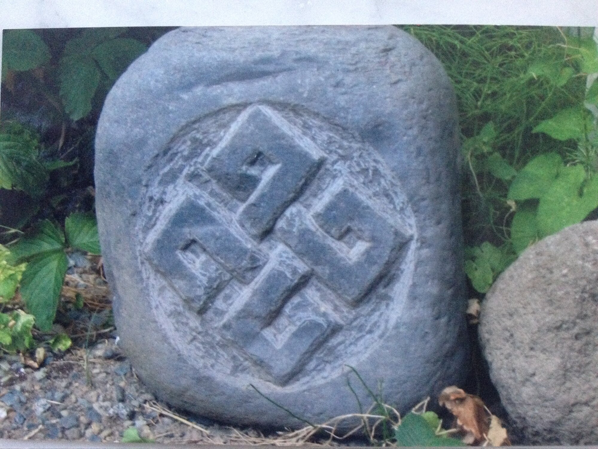 Carved knotwork medallion on a round stone
