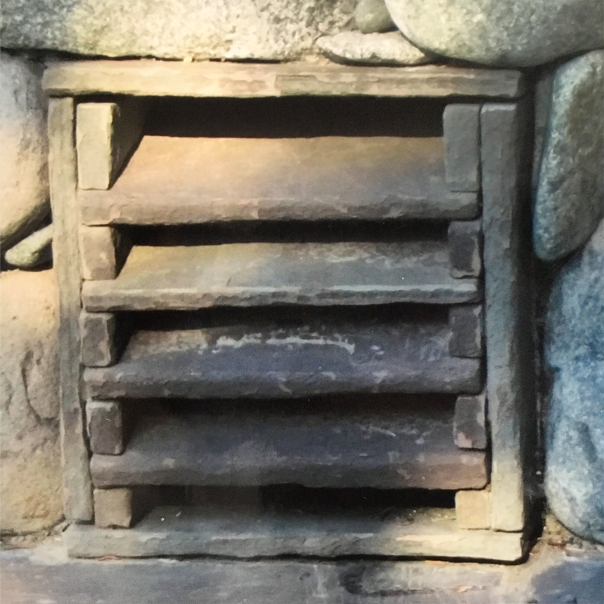Custom stone vent grate with a light stone surround