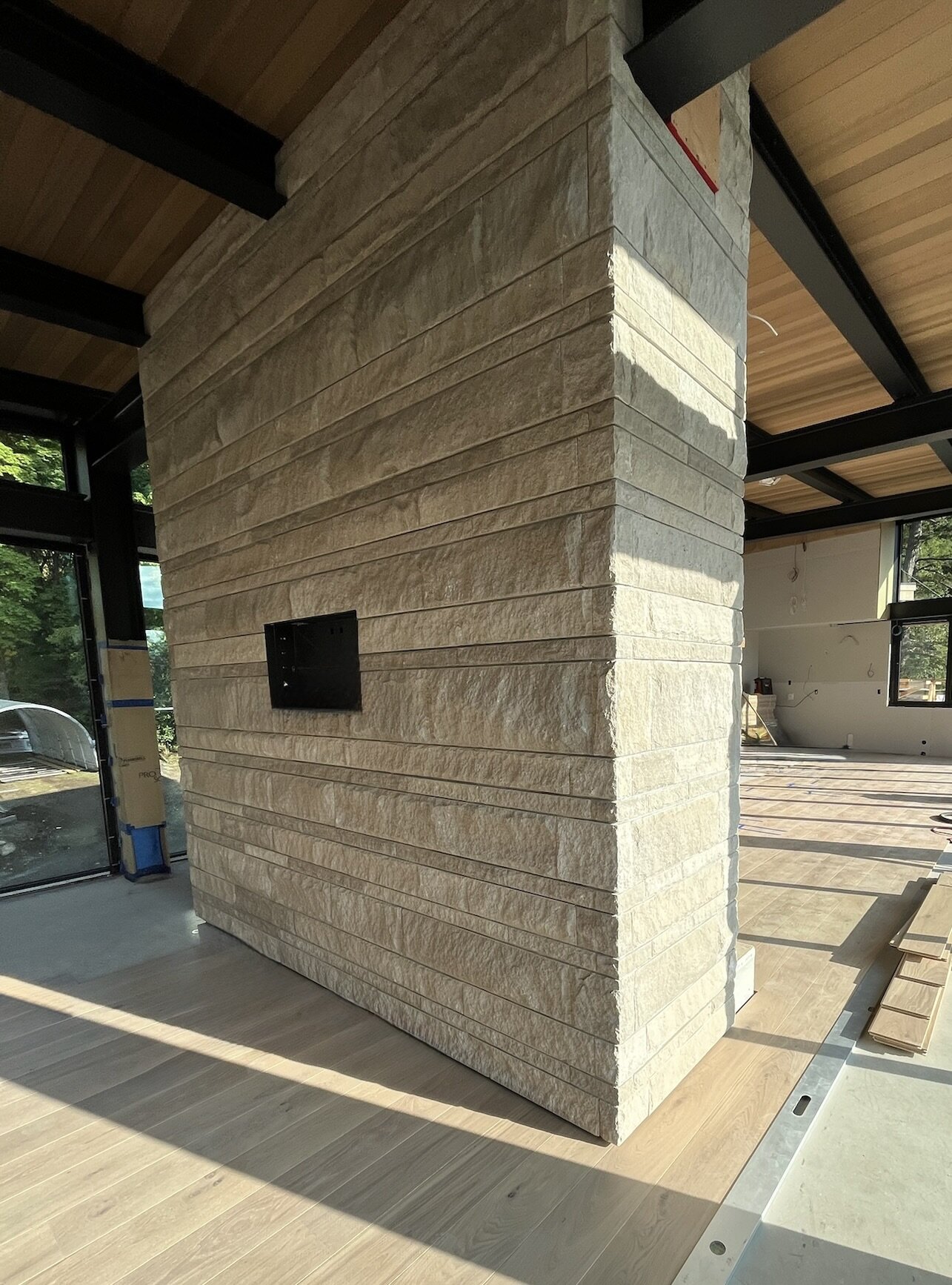 Ledgestone-clad chimney column in a home under construction