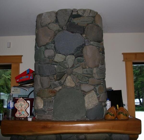 River rock chimney with a radial flower medallion detail