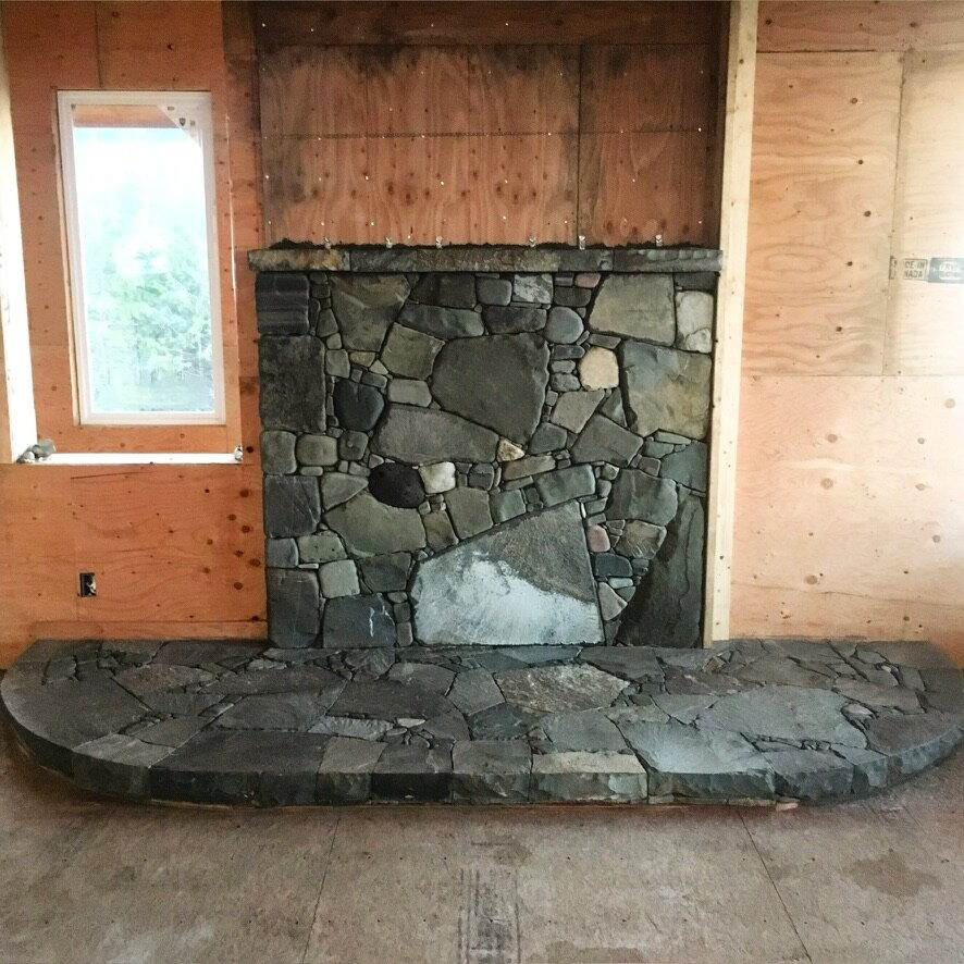 River rock fireplace with a rounded stone hearth