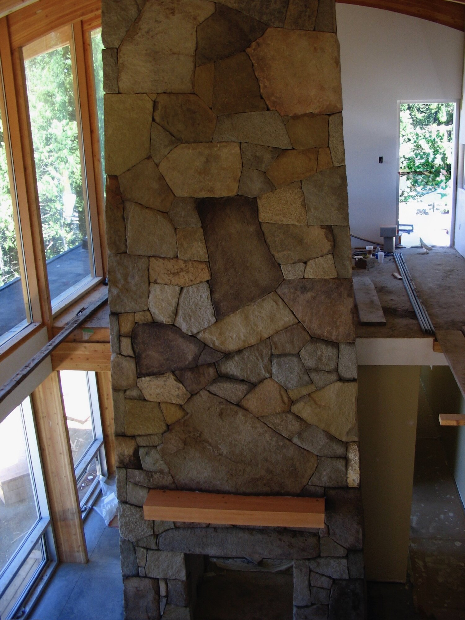 Tall flagstone fireplace column with an arched niche
