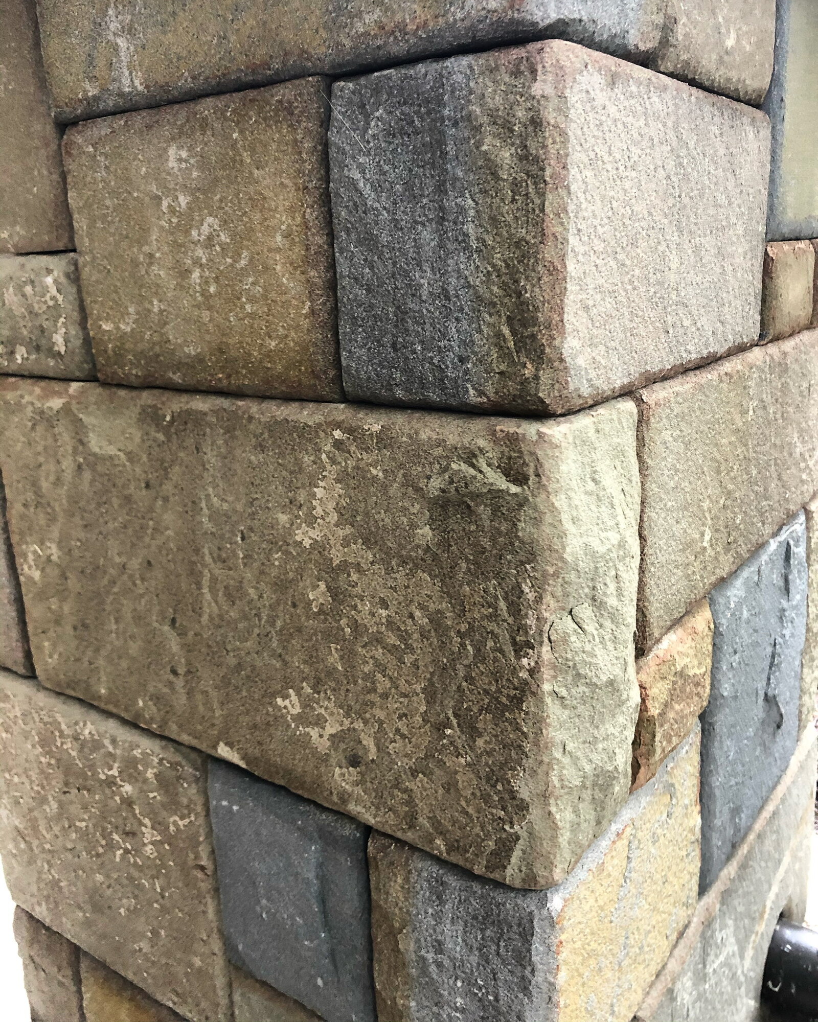 Close-up of a stone-clad post corner detail