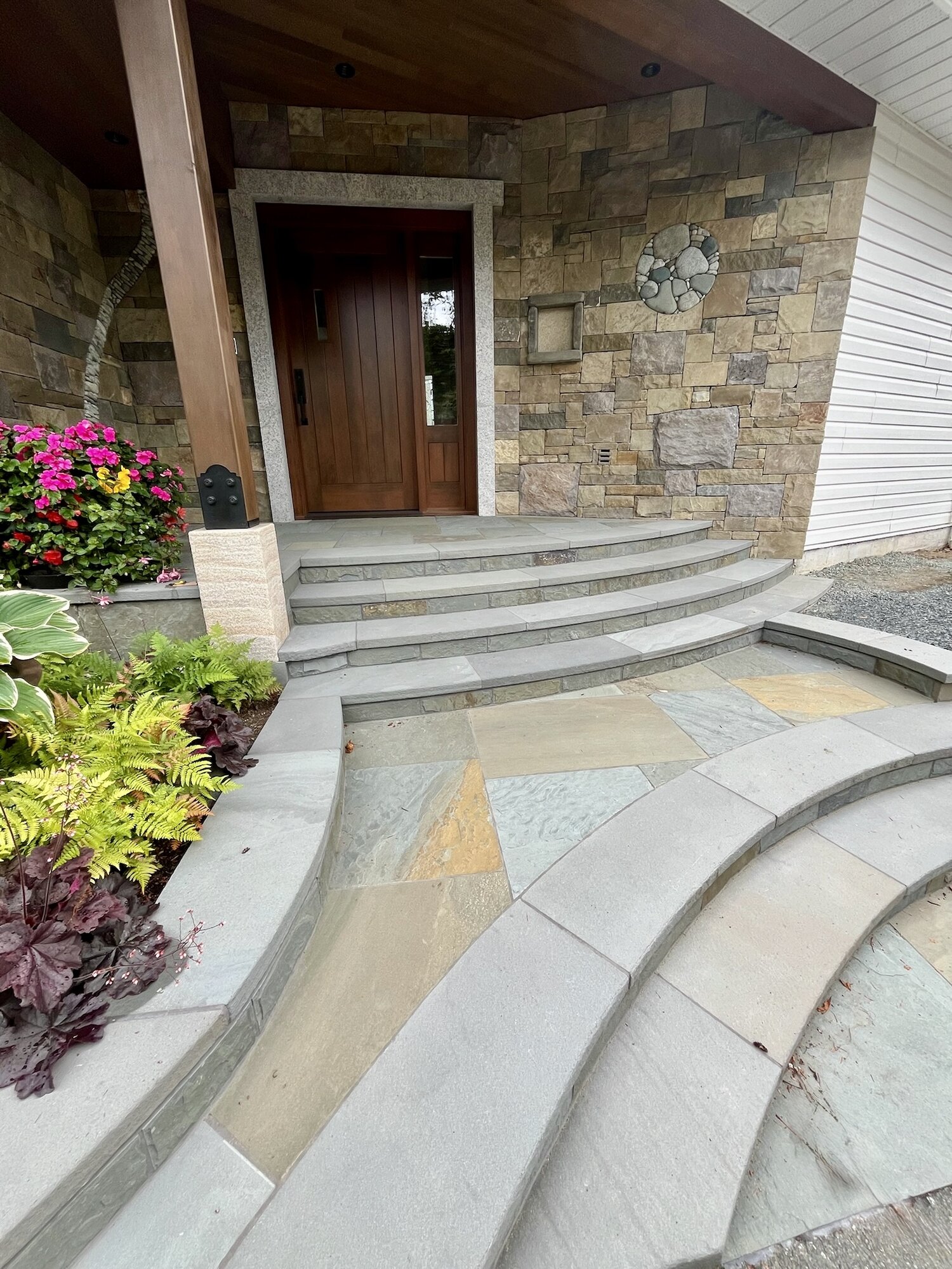 Curved stone entrance steps leading to a front door