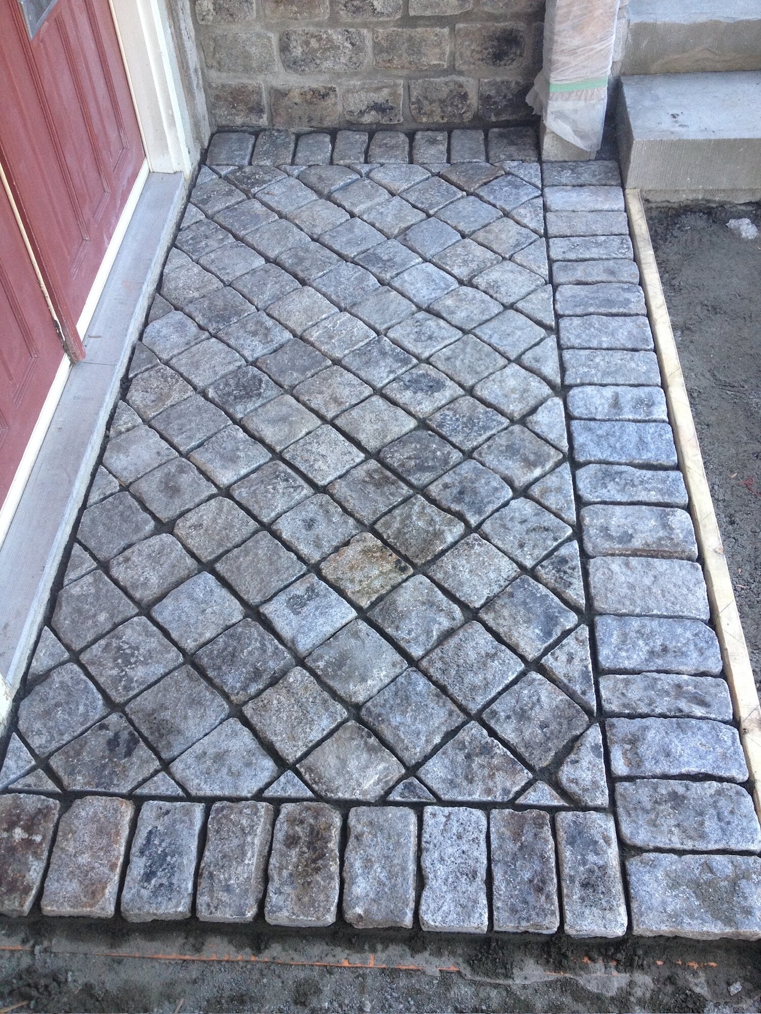 Diamond-pattern cobblestone entrance walkway