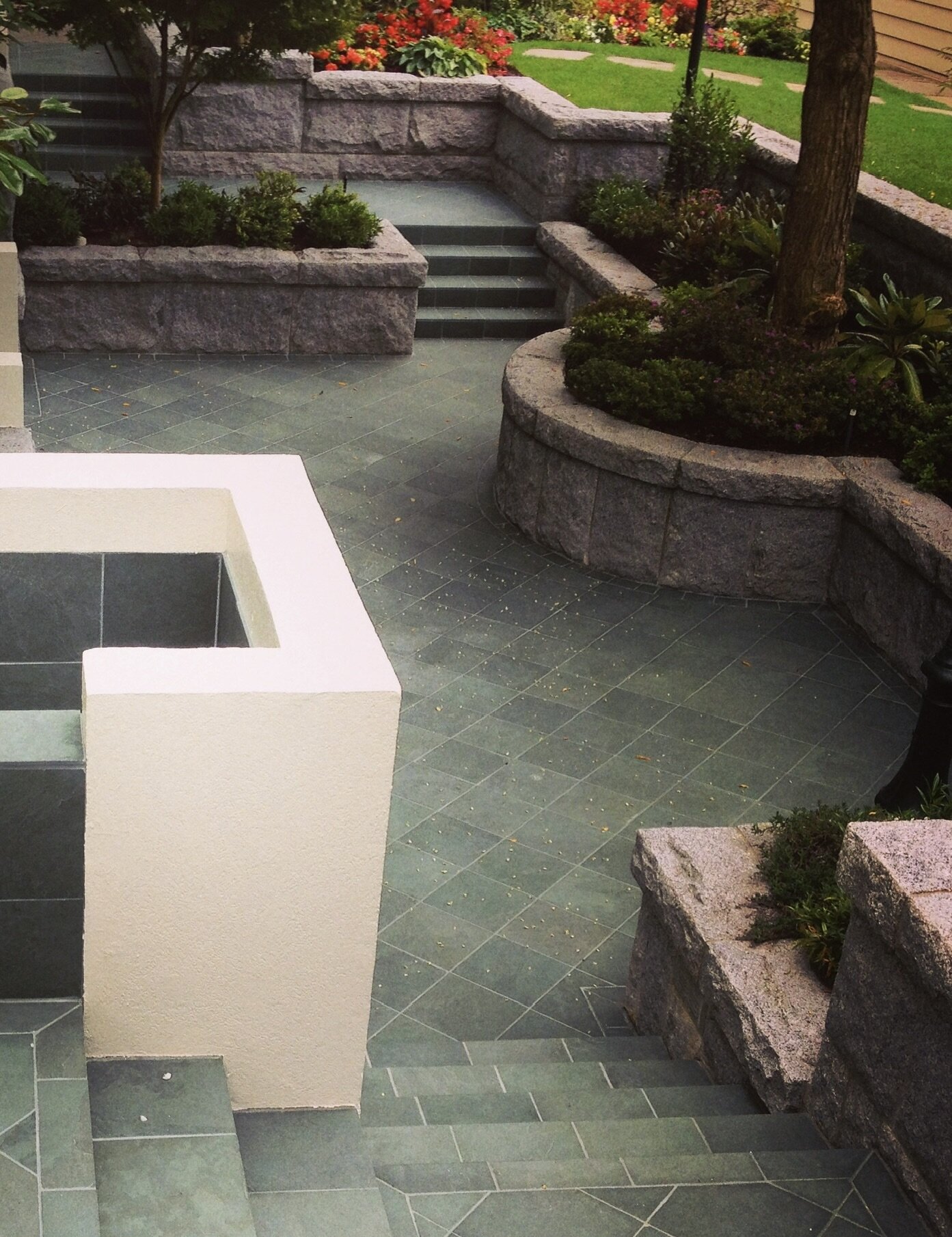 Bluestone patio with granite planters and steps