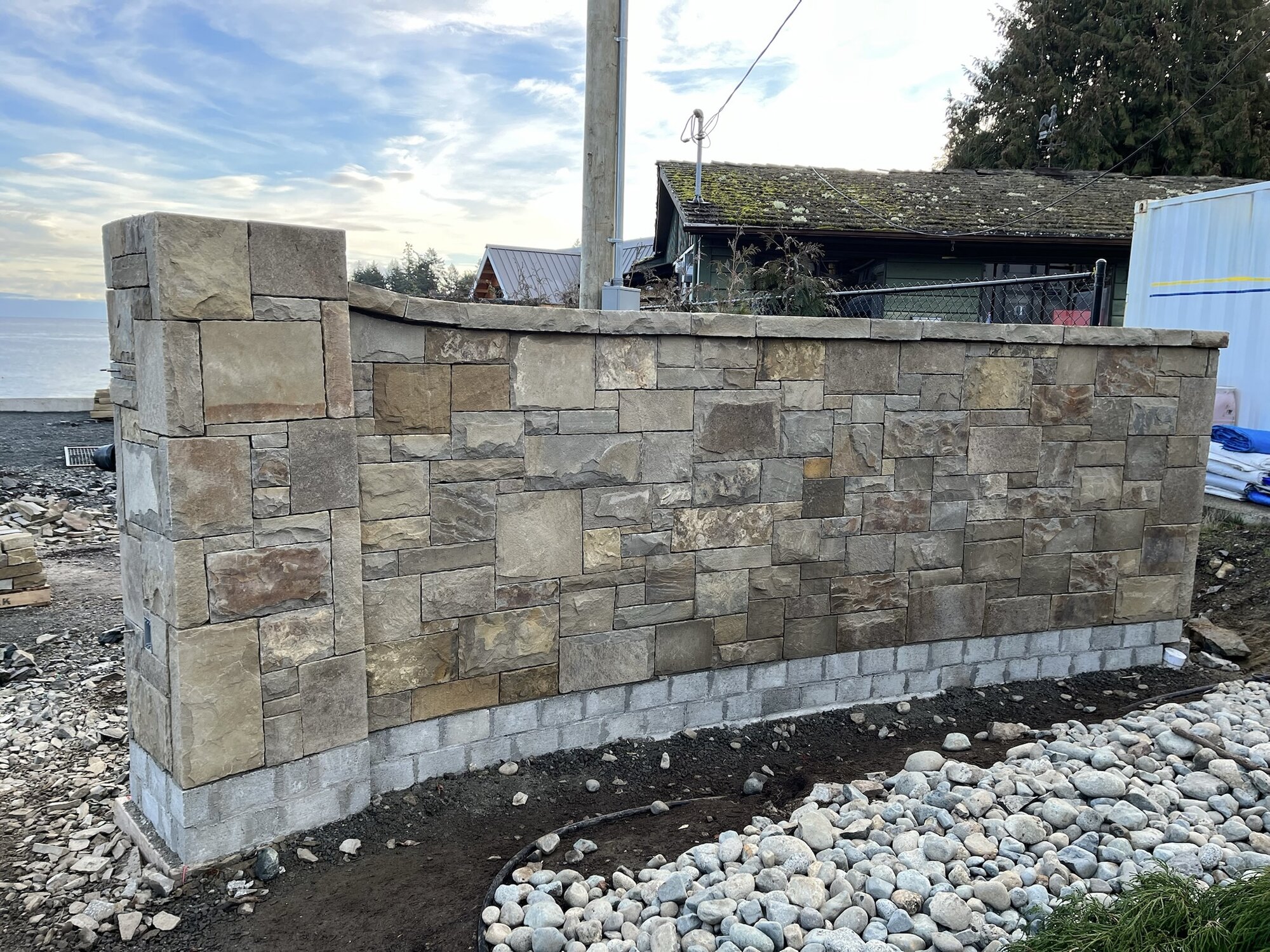 New mortared stone boundary wall with pillar at a coastal property