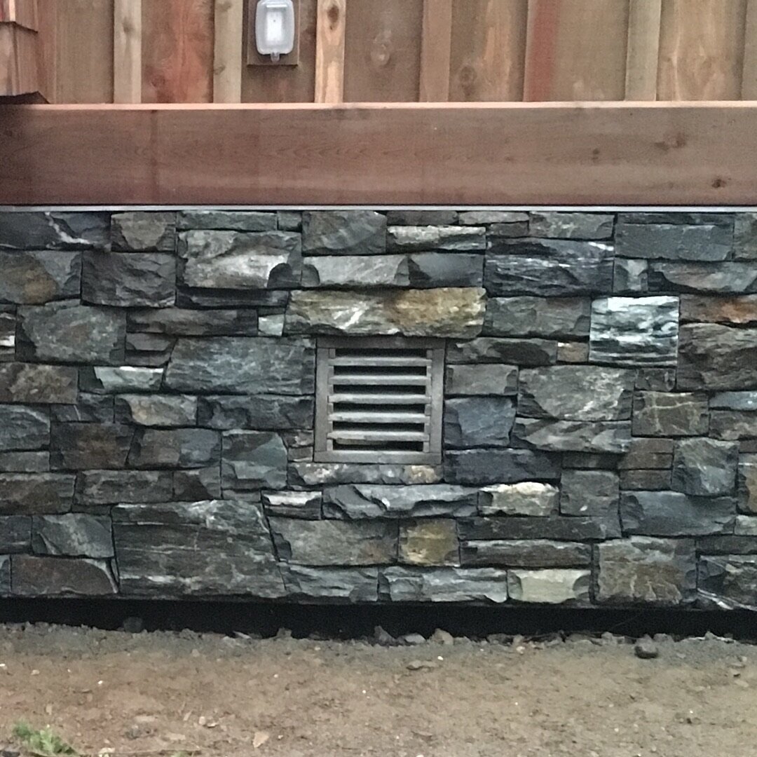 Stacked slate wall base with a vent detail